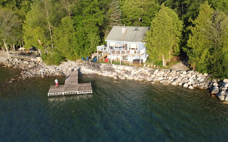 Outdoor living inspiration for Greenback: a lakefront home with a private dock and shoreline terrace